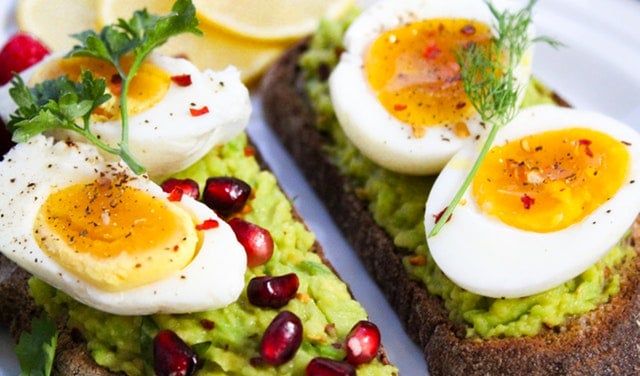 How to Boil Eggs So They Peel Easily Kitchen Appliance HQ hard-boiled egg halves on toast with avocado