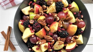 a fall fruit salad in a dark gray ceramic bowl