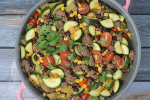 Mexican-style ground beef mixed with diced zucchini, yellow corn kernels, cherry tomatoes, and black beans