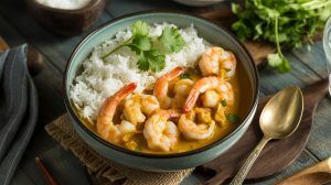 shrimp in a curry sauce over rice in a bowl