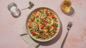 a bowl of cous cous salad with grilled vegtables