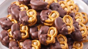 a plate of peanut butter stuffed pretzels dipped in chocolate