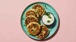 a plate of chickpea pancakes with a yogurt dipping sauce