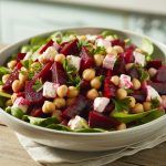 a bowl of fresh roasted beets, garbanzo beans, and cubes of feta cheese