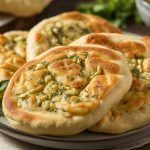 a plate of roasted garlic and herb flatbread